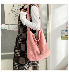 Detail of pink fleece tote bag with brown leather patch and drawstring closure