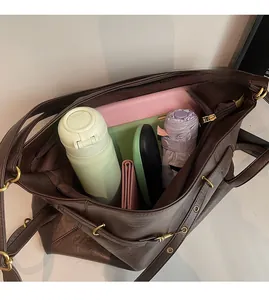 Detailed interior of a brown leather tote bag showing spacious storage for daily items