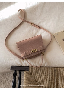 Detailed close-up of retro matte leather bag with golden hardware on a soft background
