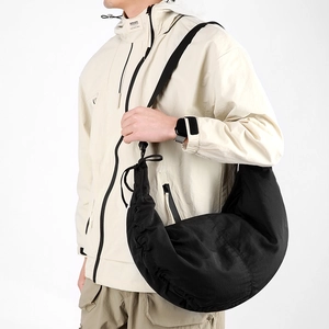 Detail of black nylon crescent bag showing durable water-resistant fabric and wide strap