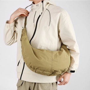 Macro view of khaki nylon crescent bag showing large capacity and soft pleated texture