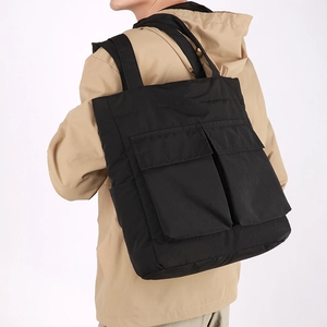 Rear view of a black nylon versatile tote backpack with large utility pockets