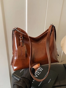 Glossy brown PU leather large capacity bucket bag with adjustable shoulder strap and silver hardware