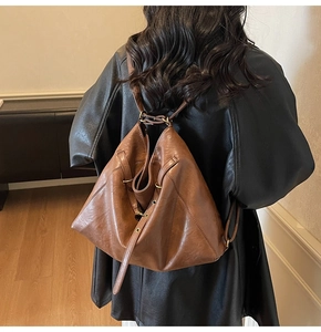 Detailed back view of brown vintage leather backpack on a model with matte PU texture