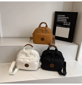Three minimalist square canvas bags with round handles and adjustable straps in different colors
