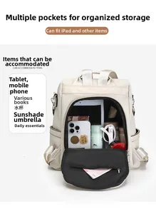 Detail view of large capacity cream backpack interior showing organized storage for iPad