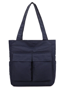 Quilted navy blue tote bag with front flap pockets for stylish daily commuting and storage