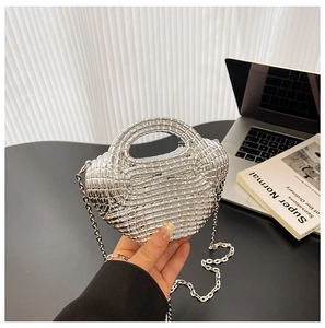 Dettaglio ravvicinato di una borsa in acrilico intrecciato argento con tracolla a catena