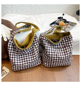 Close-up of vintage brown check tote bag with yellow fleece lining and side fashion tag