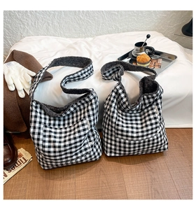 Detail of checkered tote bag showing soft faux fur lining and outer pocket for autumn