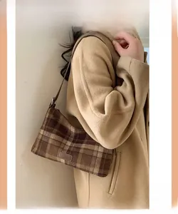 Vue détaillée du sac à bandoulière en laine à carreaux marron avec écusson en cuir Fashion