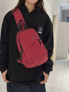 Front view of a red and white checkered crossbody bag with adjustable wide strap for daily use