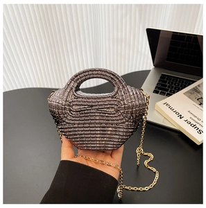 Dettaglio mini borsa in acrilico marrone con trama intrecciata e catena dorata