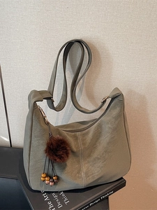 Retro moss green crescent tote bag with textured faux leather and plush charm detail