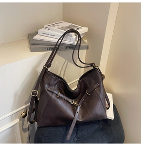 Detail of dark brown matte leather hobo bag with vintage gold buckles and large capacity