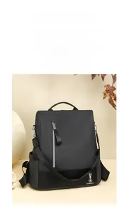 Detail shot of black nylon backpack with rabbit logo and durable faux leather base