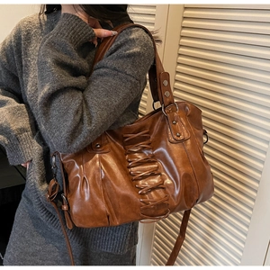 Detail view of vintage brown punk tote bag featuring unique cross-woven lace-up design