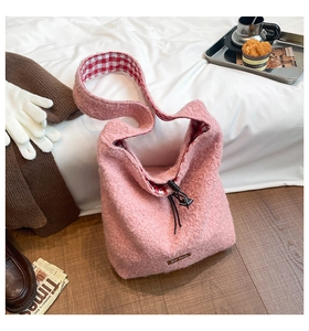 Close-up of pink fleece tote bag featuring checkered lining and drawstring closure