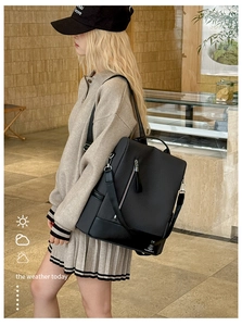 Detail of black diamond-quilted waterproof backpack with adjustable nylon shoulder straps