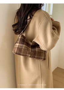 Brown plaid shoulder bag styled with a tan coat for a trendy winter fashion look