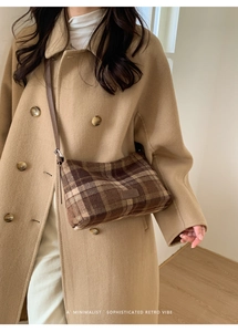 Retro brown plaid crossbody bag styled with a camel wool coat in a minimalist setting