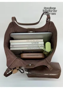 Vue de dessus de l'intérieur du grand sac cabas marron avec ordinateur et livres
