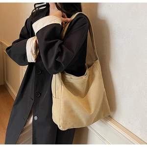 Detailed view of beige canvas tote bag showing thick texture and large capacity