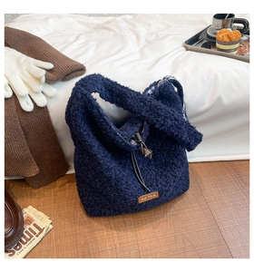 Detail of navy blue fuzzy tote bag showing plush texture and contrast check lining