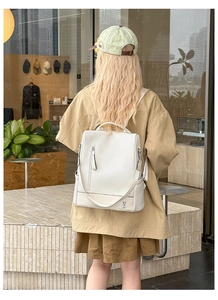 White textured leather backpack with cute rabbit logo shown on model back