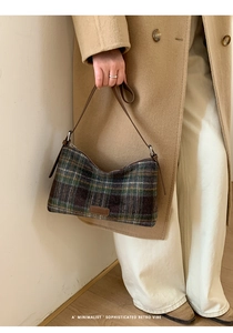 Detail of vintage plaid shoulder bag in brown and green wool with slim leather straps