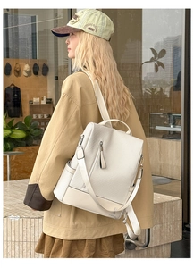 Detail of woven texture and side pocket on a cream fashion backpack for women