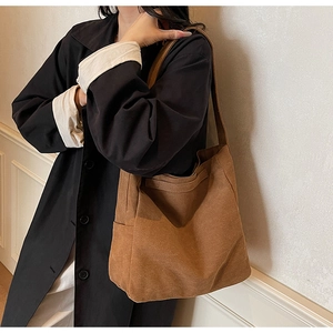 Close-up of the vintage brown canvas tote bag texture and durable shoulder strap design