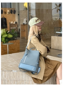 Side view of light blue fashion backpack for women featuring woven texture and rabbit logo