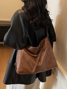 Brown large capacity leather tote bag for women showing a stylish urban commuter style