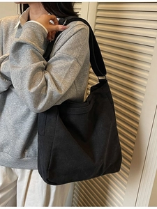 Minimalist black large capacity canvas tote bag with wide strap for daily office and school