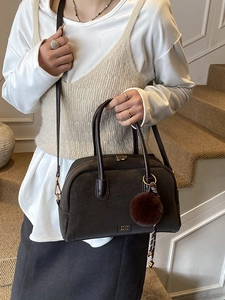 Deep brown suede vintage pillow bag with top handles and shoulder strap on model