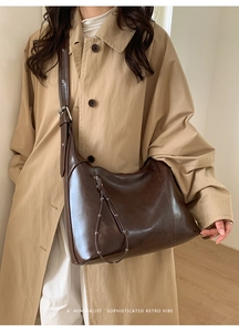 Minimalist retro dark brown large tote bag with oily leather finish worn on windcoat