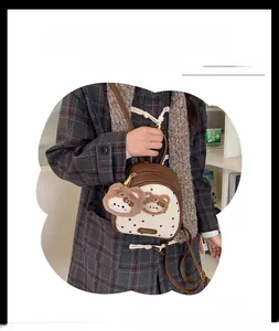 Detailed view of polka dot mini backpack with cute plush bear keychain accessory