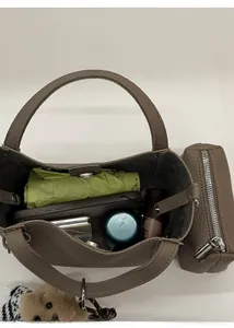 Top view of spacious bucket bag interior holding phone, lipstick and accessories