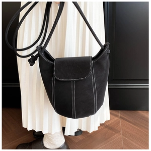 Detail of vintage black bucket bag featuring white contrast stitching and matte leather texture