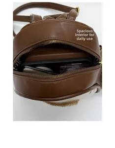 Macro view of coffee brown mini backpack interior showing storage for phone and wallet