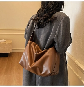 Detailed side view of large caramel hobo bag showing spacious capacity and PU texture