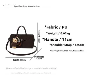 Detail showing dark brown PU handbag dimensions 30x19x12cm with bear charm and strap