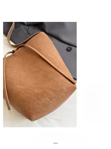 Close-up of deep brown bucket bag showing high-quality synthetic leather texture
