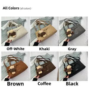 Detail view of tote bags in six colors with teddy bear pendants on white bedding
