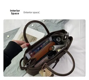 Macro view of dark brown tote bag interior with large capacity pockets and long strap