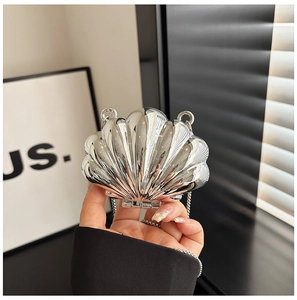 Detailed view of silver shell-shaped mini bag with metallic finish and chain strap