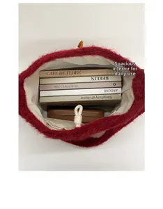 Overhead view of red plush tote bag showing spacious interior with zipper pocket and horn buckle