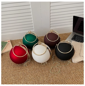 Spherical evening bags in five matte colors with gold metal rings and chain straps
