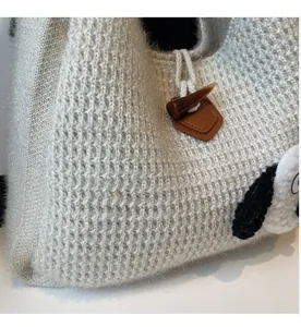 Close-up of knit fabric texture with cartoon patch and vintage toggle horn closure
